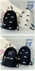 Close-up of corduroy backpack texture with bow details in black and beige colors