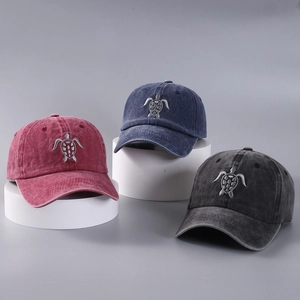 Detailed display of washed cotton baseball caps with turtle embroidery in three colors