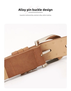 Detail of silver alloy buckle on brown suede leather belt with precise stitching
