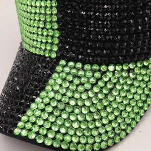 Sparkly baseball cap with green and black rhinestones for a luxury streetwear look