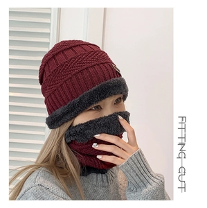 Detail of burgundy and dark grey winter knit hat with thick fleece lining and neck gaiter