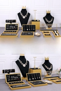 Detail of luxury black velvet and gold metal jewelry display set for necklaces and rings