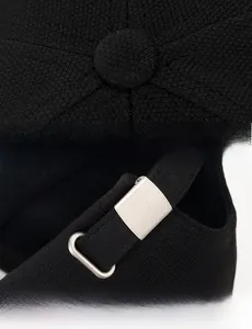 Detailed view of black baseball cap stitching and adjustable metal buckle strap