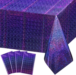 Purple laser rainbow foil tablecloth with matching party hats for birthday celebrations