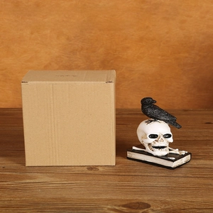 Detail view of gothic crow on skull figurine with 12x9x15cm package size measurements