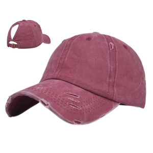 Close-up of ponytail opening and distressed cotton fabric on wine red baseball cap