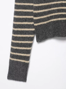Close-up of gray and beige striped knit top showing wool fabric texture and ribbed cuff