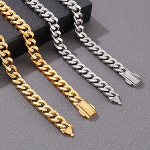 Polished gold and silver cuban link chains with box clasp on dark background