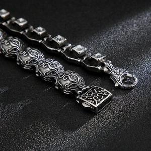 Detailed macro view of vintage silver steel bracelet with hollow carvings and zircon stone