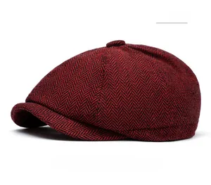 Close-up of red and black herringbone newsboy cap with thick wool tweed texture