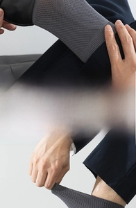 Close-up of dark grey business socks featuring elastic ribbed cuffs and premium knit texture