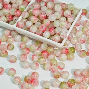 Macro shot of 10mm pink and green glass beads for DIY jewelry making and bracelets
