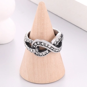 Detailed view of silver infinity ring with sparkling pavé crystals and snake texture