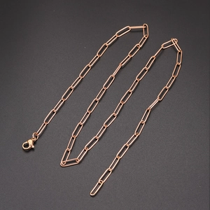 Elegant rose gold paperclip chain necklace with lobster clasp on dark matte background