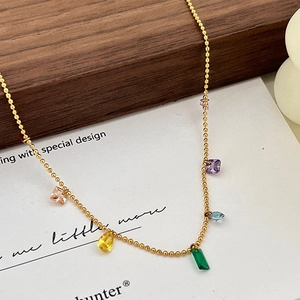 Detail of 14K gold beaded necklace featuring colorful zircon charms and gemstones