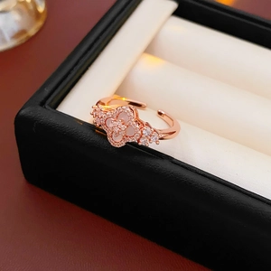 Macro shot of rose gold flower ring with zircon and mother of pearl on a jewelry box