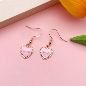 Detailed view of pink enamel heart earrings with gold metal and Love inscription