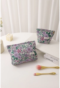 Detail of vintage floral jacquard cosmetic bags with embroidery and metal zipper