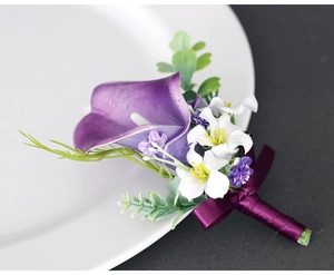 Detailed view of handmade dark purple calla lily boutonniere with satin ribbon stems