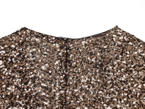 Macro shot of high-density bronze sequins and round neckline stitching detail