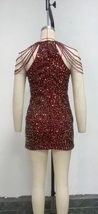 Detail of beaded back straps on a burgundy sequin mini dress with cross-back design