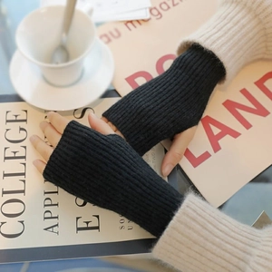 Detail of black ribbed knit fingerless gloves for women, perfect for winter typing