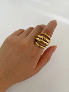 Detail of 18K gold plated multi-layer ring with twisted texture on a model's hand