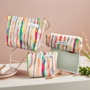Rainbow striped knit pouches set with medium crossbody bag and small zip organizers