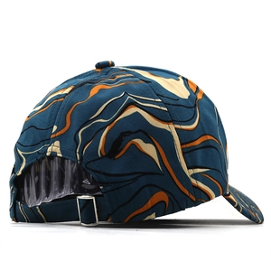 Detail view of tie-dye baseball cap with blue-green marble print and metal back buckle
