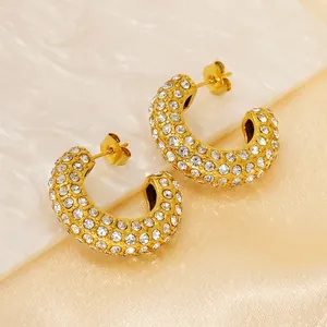 Golden C-shaped stainless steel earrings with sparkling rhinestones from a 45-degree angle