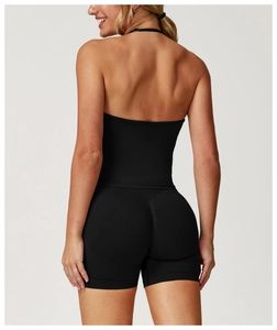 Rear view of black seamless yoga jumpsuit featuring cross-back cut and V-line stitching