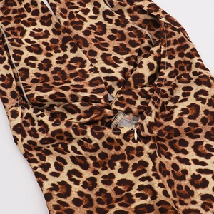 Detail of leopard print dress featuring a waist knot design and hidden back zipper closure