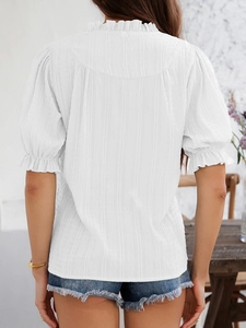 Rear view of white textured blouse featuring feminine ruffle collar and bell sleeves detail