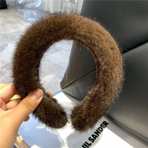 Detail view of a thick dark brown faux mink fur headband with a soft and fluffy texture