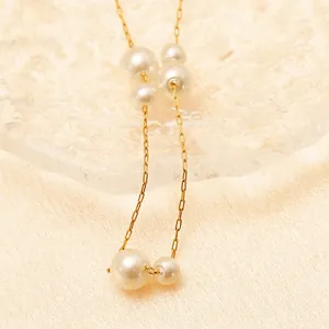 Elegant stainless steel pearl bracelet with layered white pearls and golden link chain