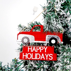 Red Christmas truck wooden ornament with Happy Holidays sign on a snowy tree