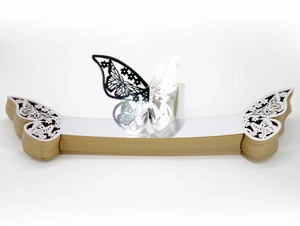 Macro view of silver butterfly paper napkin rings with laser-cut hollow design detail