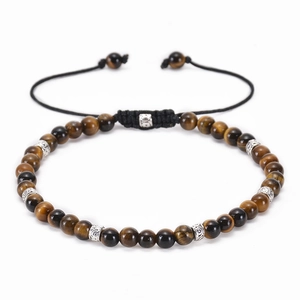 Detailed macro view of 8mm tiger eye stone beads and silver engraved spacers with drawstring