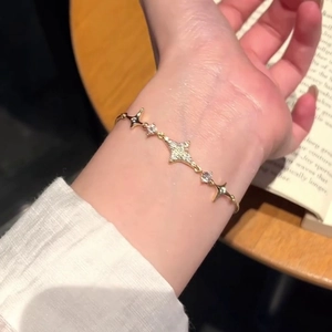 18k gold plated bracelet with star pendant and sparkling zircons on a model wrist