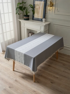 Detailed view of grey Christmas deer jacquard patterns with beige fringed tassels on edges