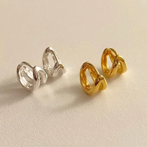 Close-up of dual-layer S925 sterling silver hoop earrings in gold and silver finish