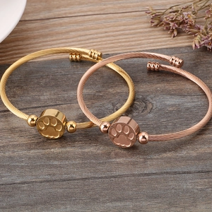 Chic gold and rose gold stainless steel cable bracelets featuring a pet paw print charm