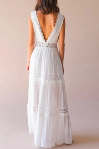Detailed back view of white lace maxi dress with elegant backless V-neck design