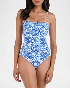 Detailed view of blue ethnic print one-piece swimsuit with spaghetti straps and floral pattern