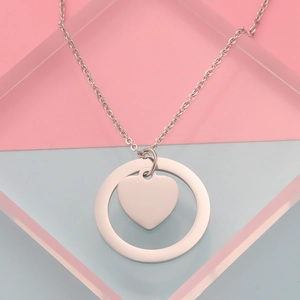 Detail van gepolijste roestvrijstalen ring- en hartvormige hanger aan een zilveren O-ketting