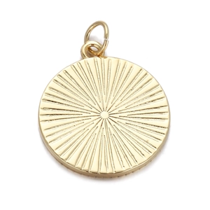 Detail of a gold circular pendant with sunburst texture on a clean white background