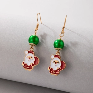 Close-up of festive Santa Claus earrings with colorful enamel and gold finish