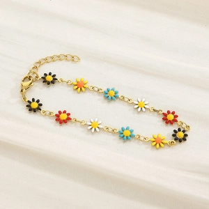 Detail of gold chain bracelet with colorful enamel daisy charms and lobster clasp