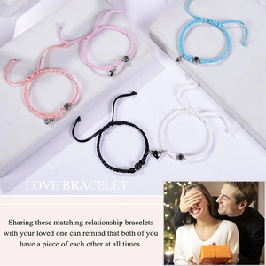 Detailed view of woven 100 languages I love you projection heart magnet couple bracelets