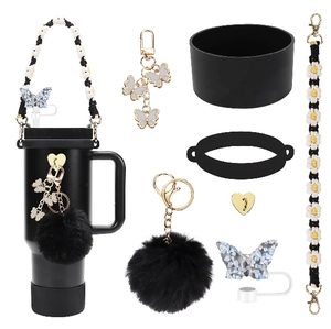 Detailed set of black silicone straw covers and daisy charms for Stanley tumbler